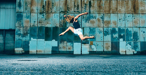 istock Female dancer runs and jumps into the air 484771044