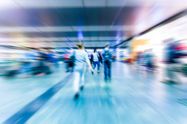 people walking in metro station on rush hour,blurred background