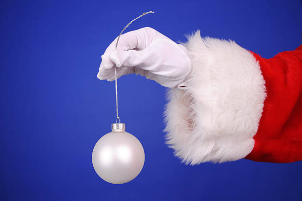 istock Santa Hand Holding A Ornament 484774776