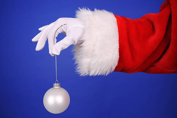 istock Santa Claus Hand Holding A Ornament 484774780
