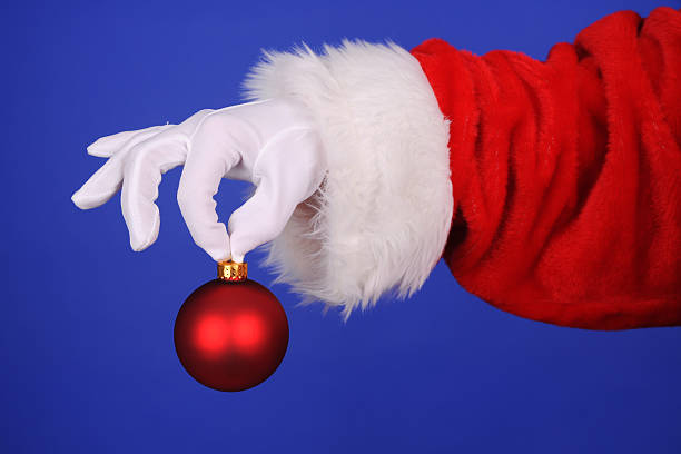 istock Santa Claus Hand Holding A Ornament 484774786