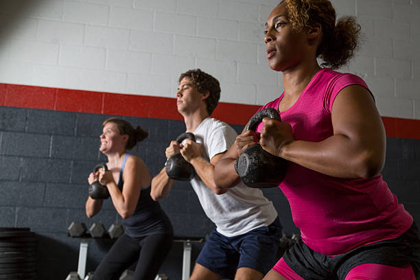istock Two Women and a Man Doing Kettlebell Squats 484775178