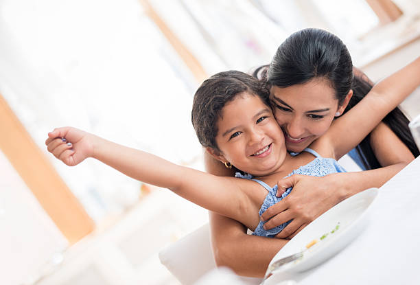 istock Mother hugging her daughter after she ate dinner 484775478