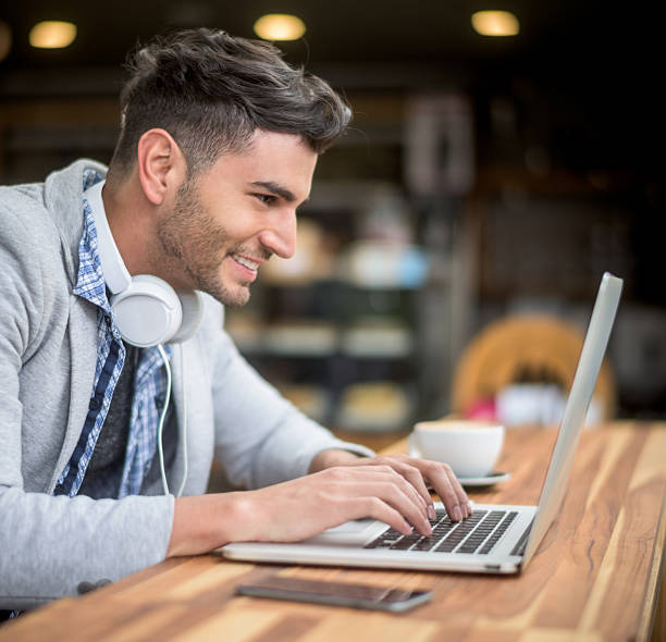 istock Young man working online at a coffee shop 484775506