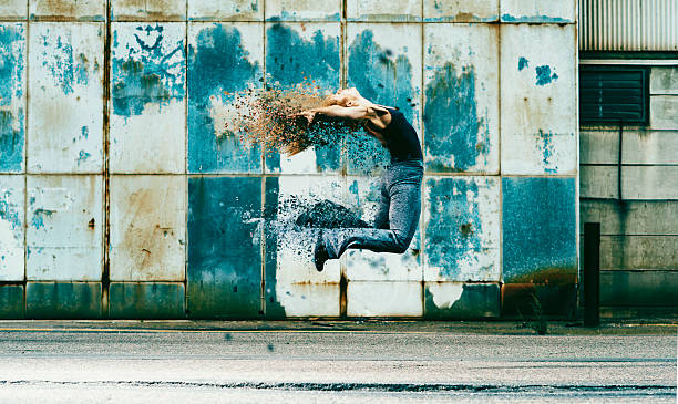 Woman jumps into the air and her body dissolves