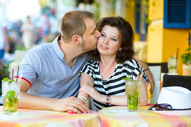 istock happy couple drinking lemonade or mojito in an outside cafe 484783020