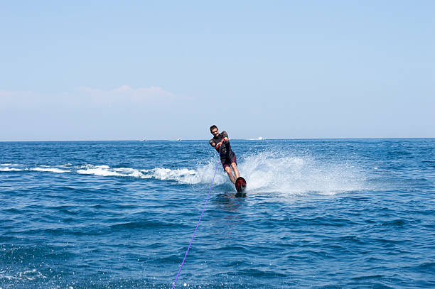 istock Attractive young man is skiing on water 484787056