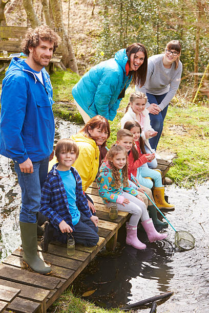 istock Adults With Children On Bridge At Outdoor Activity Centre 484787246