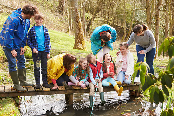 istock Adults With Children On Bridge At Outdoor Activity Centre 484787252