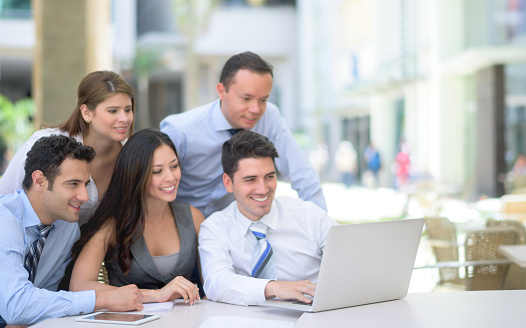 Group of business people in a meeting working online using a laptop