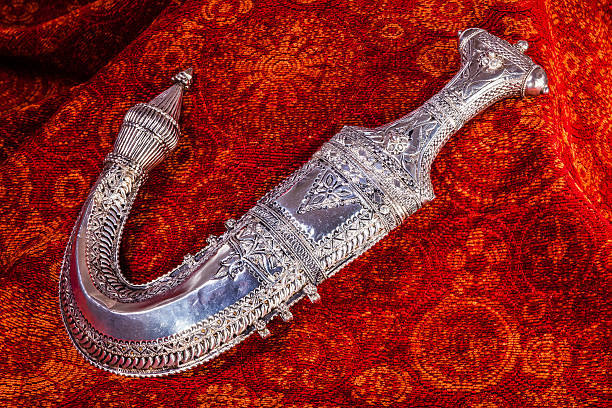 istock Arabian Silver Dagger on rich, red fabric - close-up 484794762