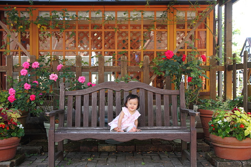 Japanese baby girl sitting on the bench