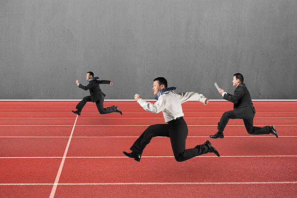 istock Three businessmen running on red track 484795860
