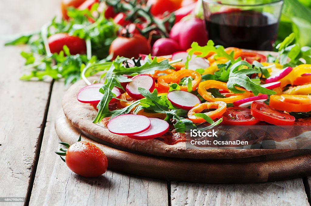 Vegan pizza with radish, tomato and paprika Vegan pizza with radish, tomato and paprika, selective focus 2015 Stock Photo