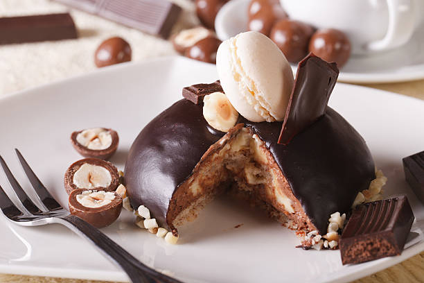 istock Sliced chocolate cake decorated with nuts and macaroon 484798834