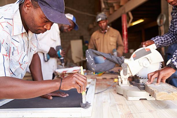 homens no trabalho em um workshop de carpintaria para construções, áfrica do sul - south africa waist up indoors image technique imagens e fotografias de stock