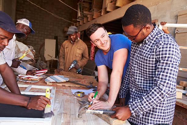 homens no trabalho em um workshop de carpintaria para construções, áfrica do sul - south africa waist up indoors image technique imagens e fotografias de stock