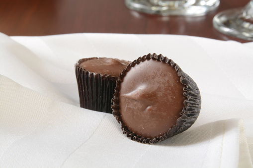 Small peanut butter cups on a white napkin