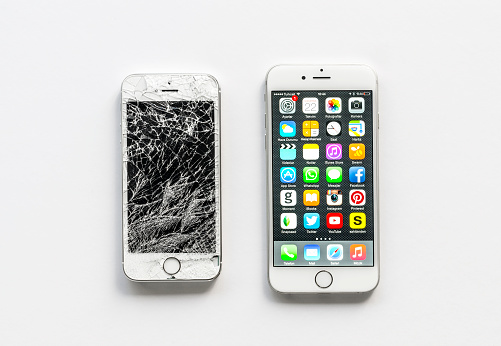 Antalya, Turkey - April 22, 2015: Apple iPhone 6, the newest version of this revolutionary mobile device displaying the home page and iPhone 5s with broken screen