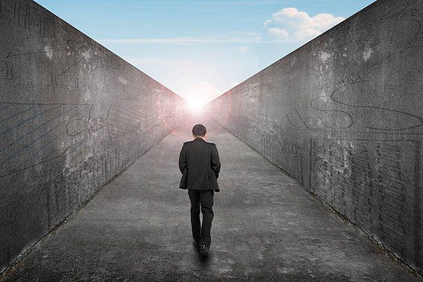 istock Businessman walking one way road toward exit sun sky view 484799736