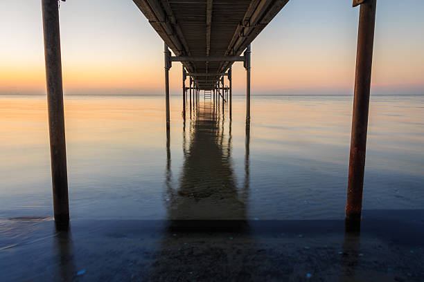 istock Under the Jetty at Sunrise sunset time on the beach 484800494