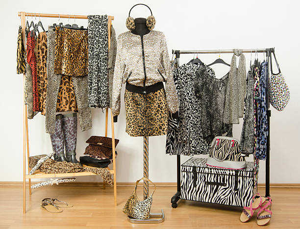 istock Dressing closet with animal print clothes arranged on hangers. 484803416
