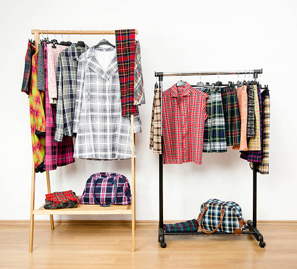 istock Dressing closet with plaid clothes arranged on hangers on racks. 484804306