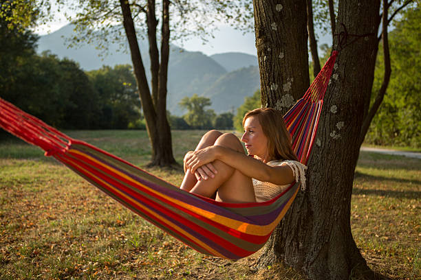 istock Young woman relaxing on a hammock in summer 484806746