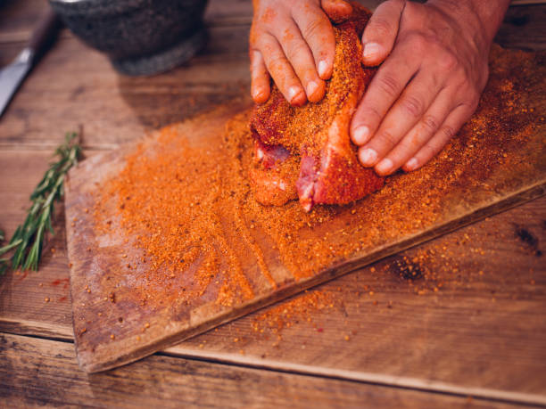 istock Dry spicy seasoning being rubbed into raw pork 484806820
