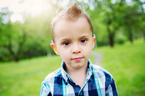 A Portrait of cute little boy child outdoors on the nature