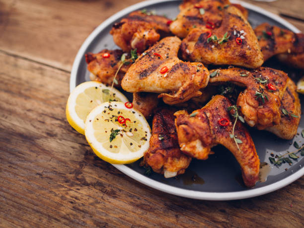 Chillie sprinkled spicy chicken wings on a wooden table