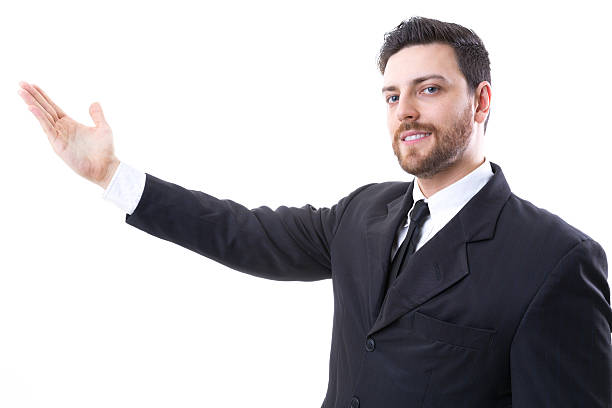 istock Businessman showing something on white background 484807868