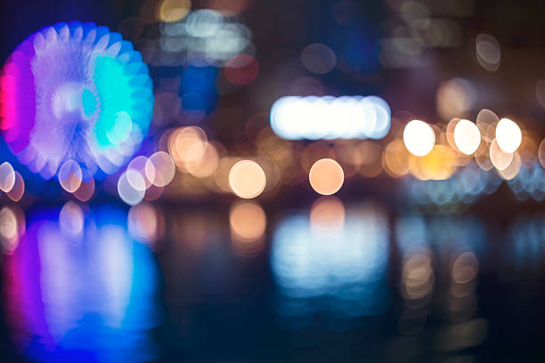 istock Blurred bokeh night harbor lights backdrop with ferris wheel 484809216