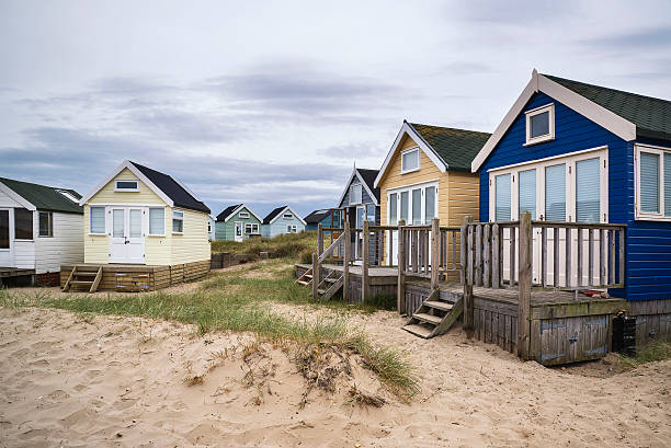 istock Lovely beach huts on sand dunes and beach landscape 484809400