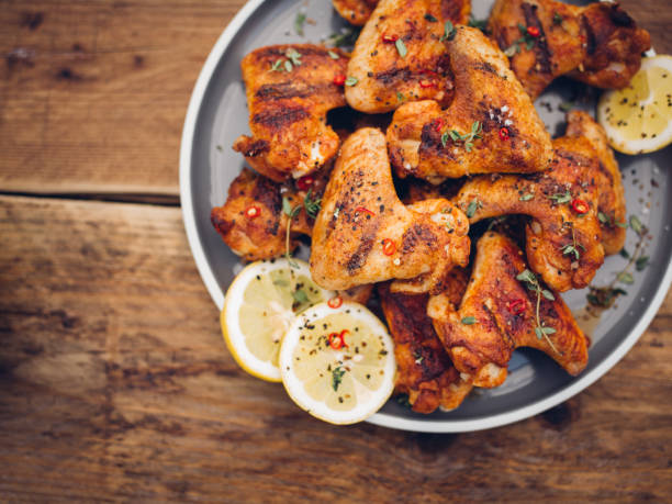istock Crispy chillie sprinkled chicken wings on a plate 484811804
