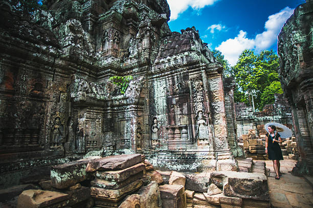 istock Woman walks through Angkor Wat with Umbrella 484812246