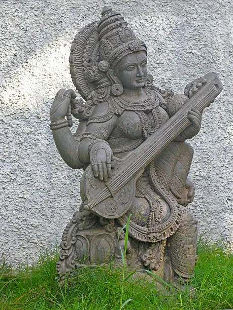 A statue of Indian Goddess Saraswati, known as goddess of speech and eloquence, near kovalam beach. Trivandrum, Kerala, India