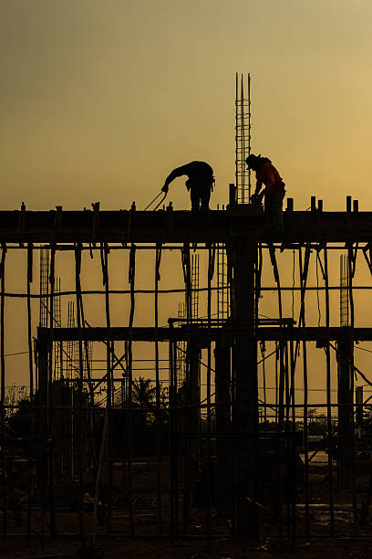 silhouette of constructionworker on constructionsite stock photo