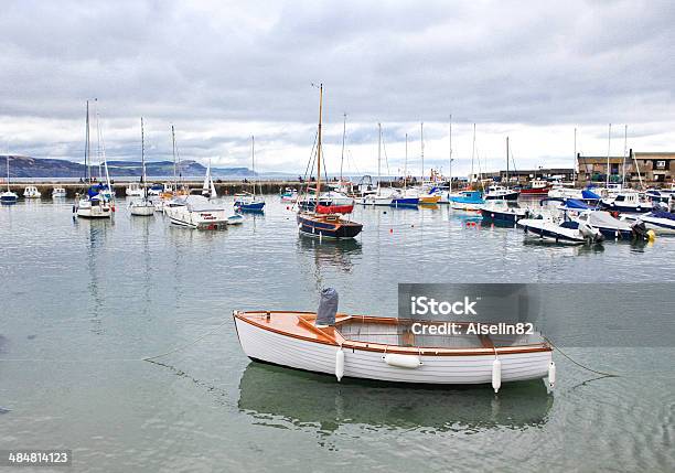 Boats In Lyme Regis Harbour In Dorset Uk Stock Photo - Download Image Now - Bay of Water, Beach, Built Structure