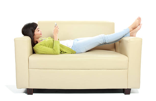 istock Young girl using her cellphone on the couch 484816395