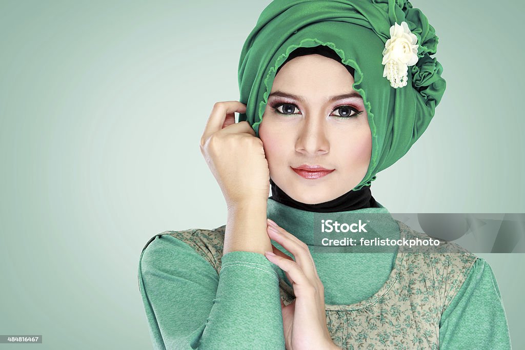 portrait of beautiful woman wearing hijab Fashion portrait of young beautiful muslim woman with green costume wearing hijab Beauty Treatment Stock Photo