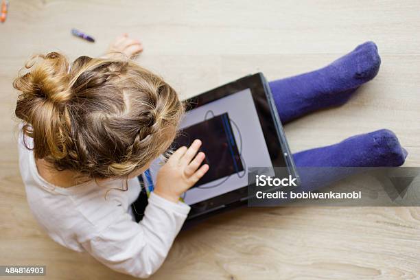 Little Girl With A Digital Tablet Stock Photo - Download Image Now - Girls, Digital Tablet, Playing