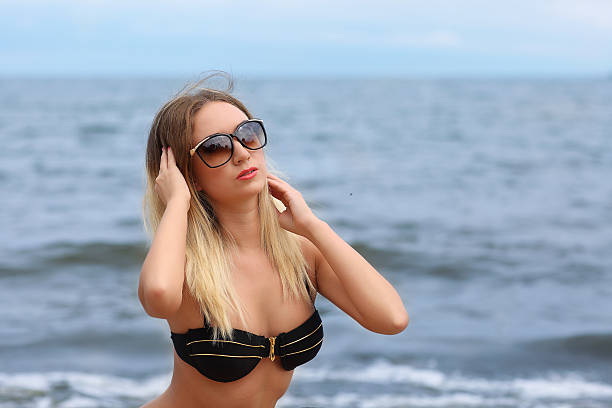 istock Beautiful young woman in bikini on the sunny beach 484817524