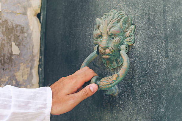 Holding lion doorknob. Close up