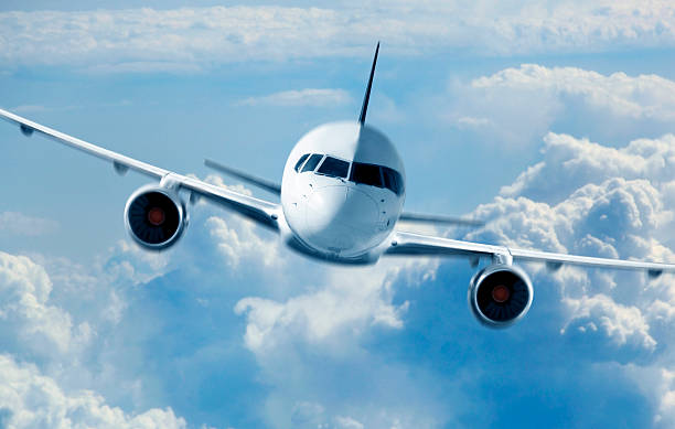 istock Passenger Airliner flying in the clouds 484817822