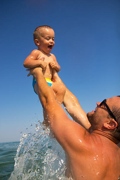 istock Dad and son enjoying on vacation at sea 484818632