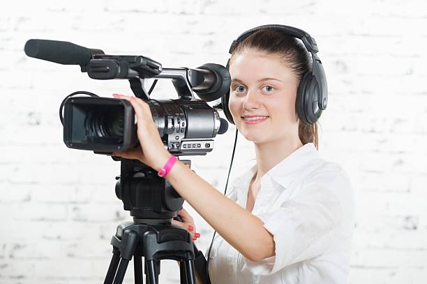 istock pretty young woman with a professional camera 484823486