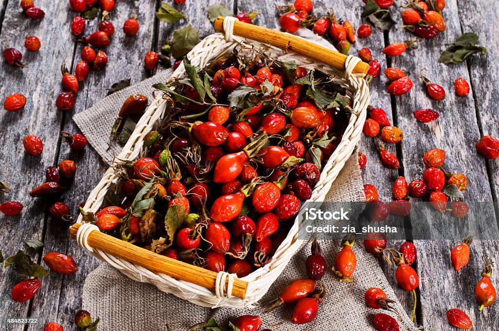 Rosehips Rosehips in a wicker basket on a wooden surface 2015 Stock Photo