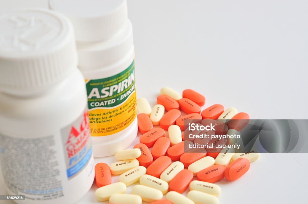 Pills of aspirin and advil Coquitlam, BC, Canada - August 01, 2015 : Pills of aspirin and advil on white background 2015 Stock Photo