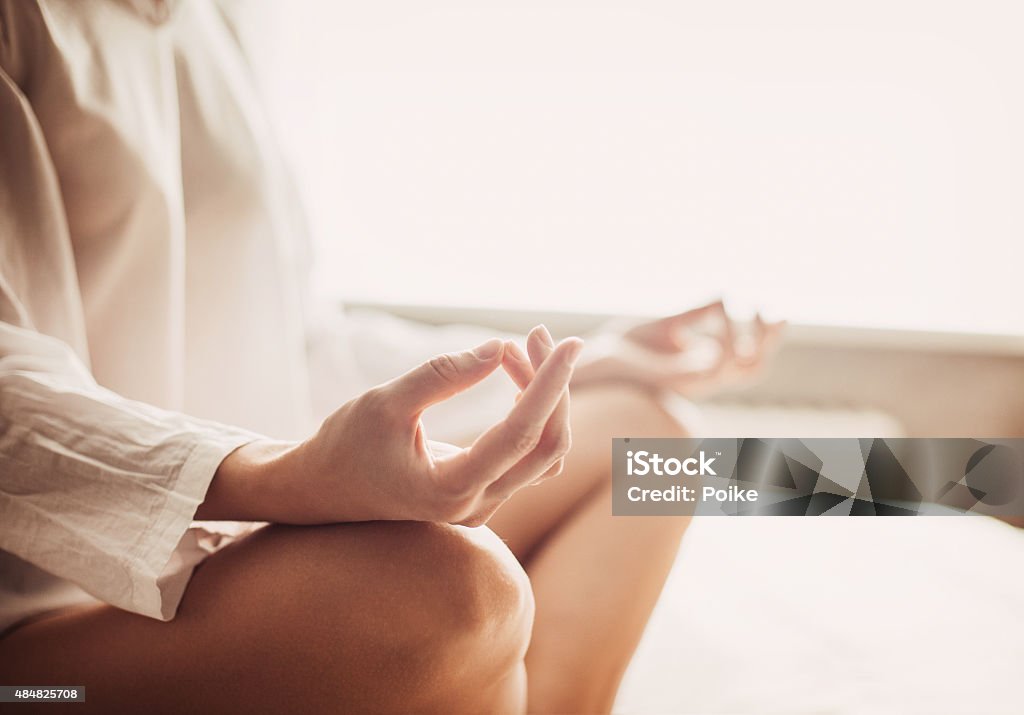 Relaxation at home Hands of young beautiful woman practicing yoga at home Coach Stock Photo